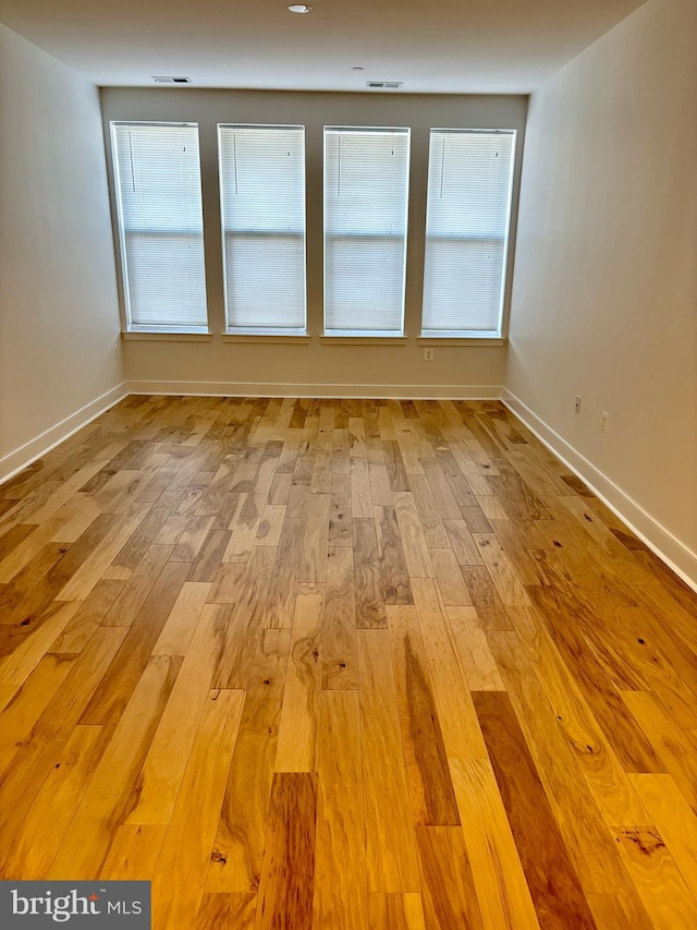 empty room with light hardwood / wood-style floors