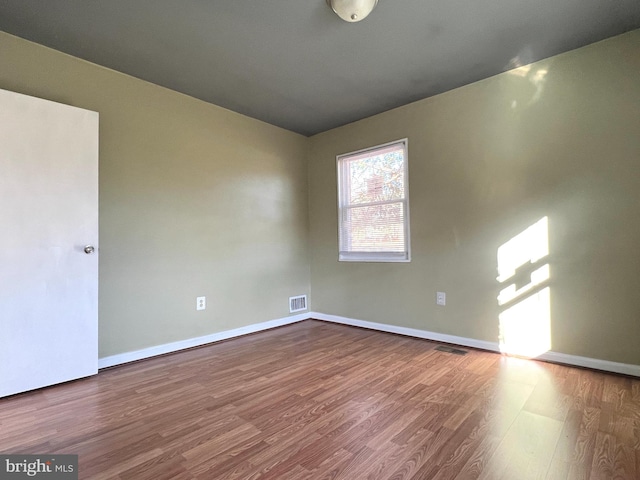 unfurnished room featuring hardwood / wood-style floors