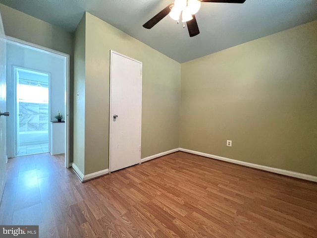 unfurnished room featuring hardwood / wood-style floors and ceiling fan