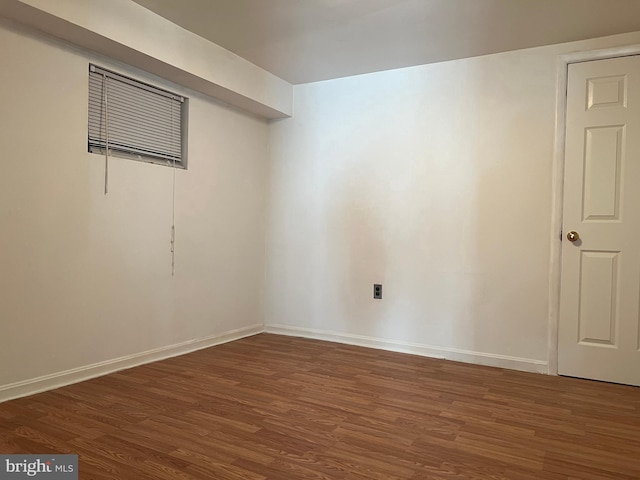 basement with dark hardwood / wood-style flooring