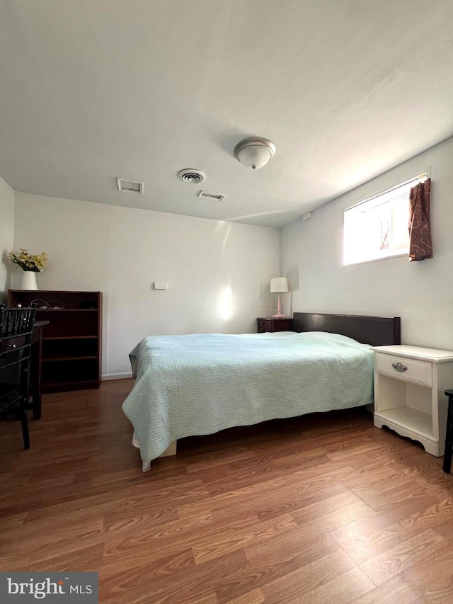 bedroom with hardwood / wood-style floors