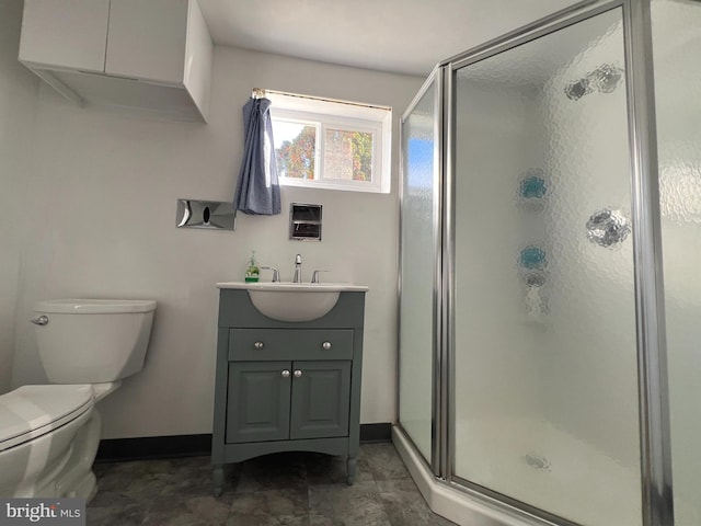 bathroom featuring walk in shower, vanity, and toilet