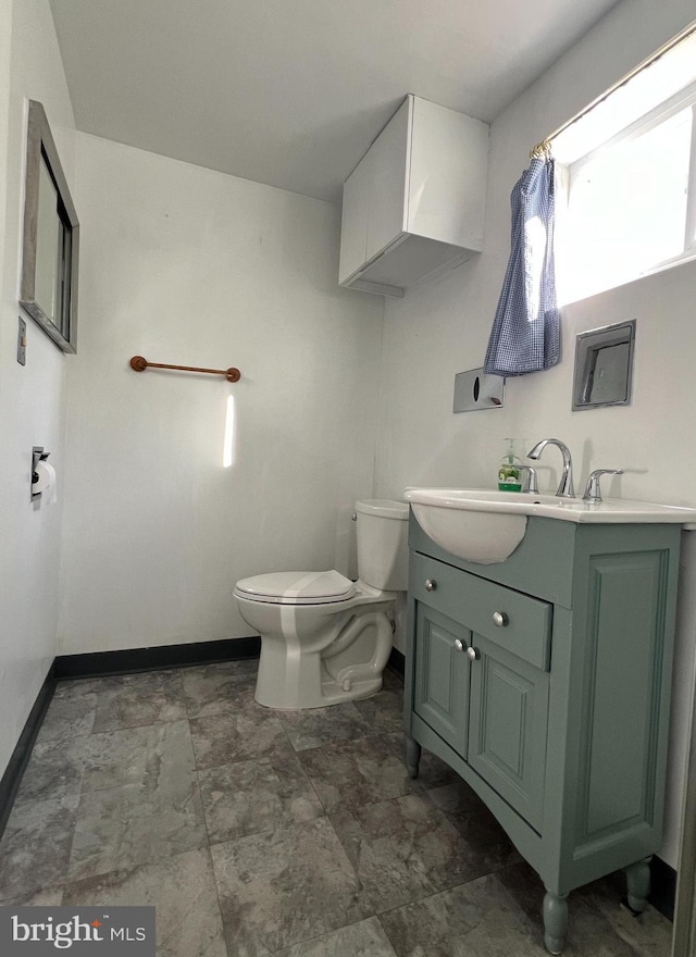 bathroom with toilet and vanity