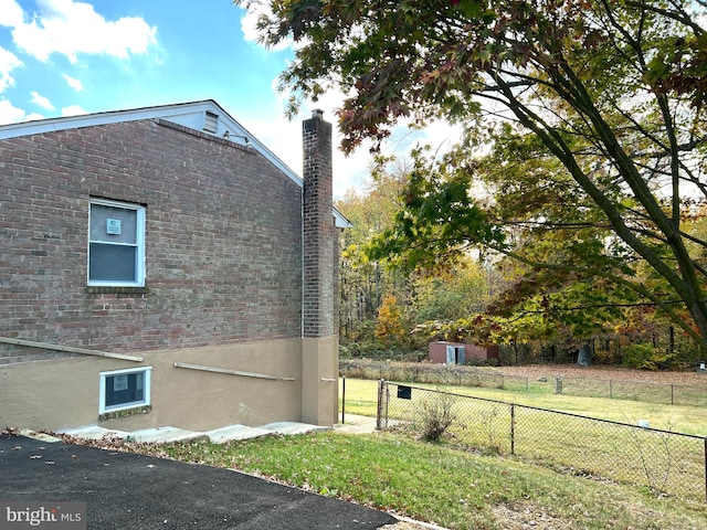 view of side of home featuring a yard