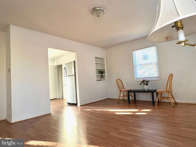 interior space featuring built in features and hardwood / wood-style flooring