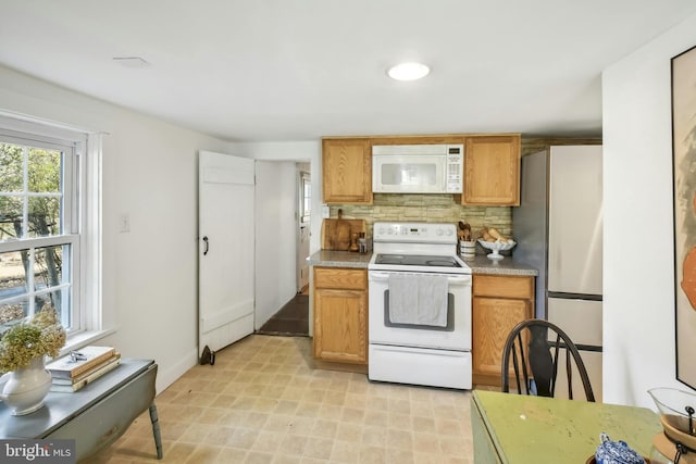 kitchen with white appliances and backsplash