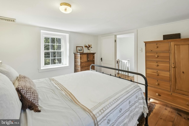 bedroom with wood-type flooring