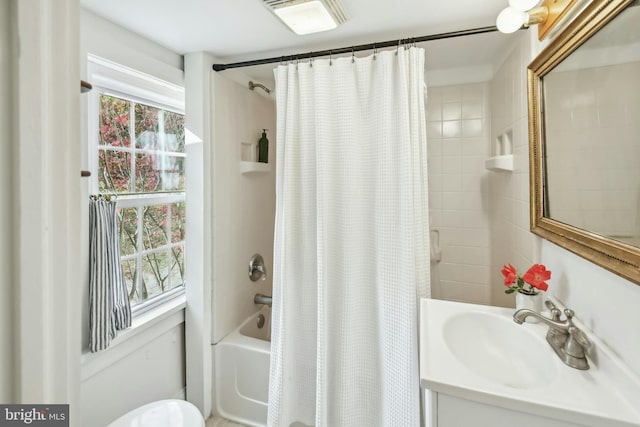 bathroom with shower / tub combo with curtain, vanity, and a wealth of natural light