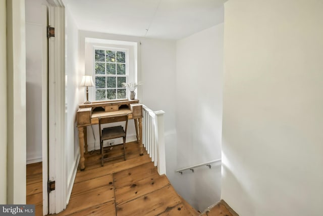 staircase with hardwood / wood-style floors