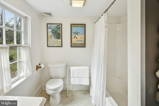 bathroom with plenty of natural light and toilet