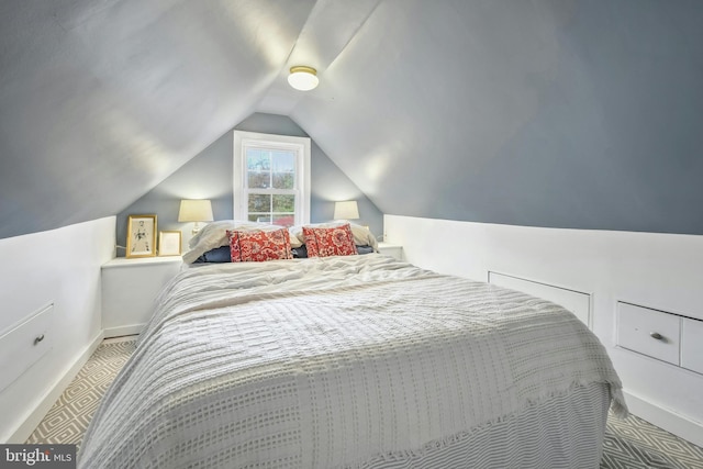 carpeted bedroom featuring lofted ceiling