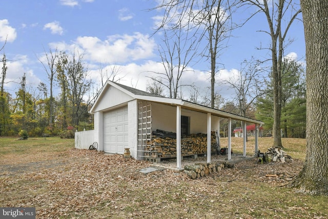 view of property exterior featuring a garage and an outdoor structure