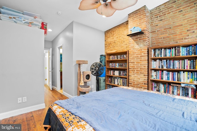 bedroom with hardwood / wood-style floors and ceiling fan