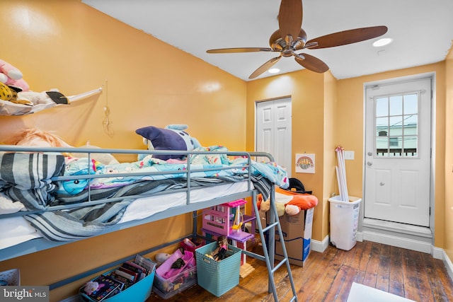 bedroom featuring dark wood-type flooring, ceiling fan, and a closet