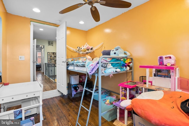 bedroom with dark hardwood / wood-style flooring and ceiling fan