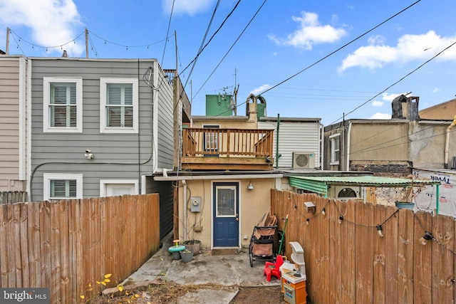 back of property with a balcony