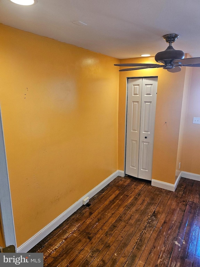 interior space with dark hardwood / wood-style flooring and ceiling fan