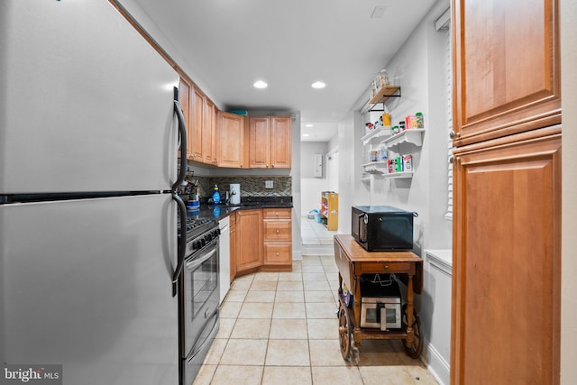 kitchen featuring light tile patterned flooring, stainless steel appliances, and backsplash