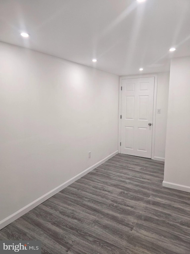 basement with dark hardwood / wood-style floors