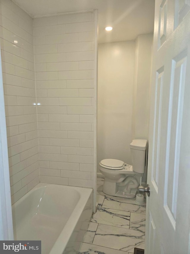 bathroom featuring toilet, marble finish floor, and recessed lighting