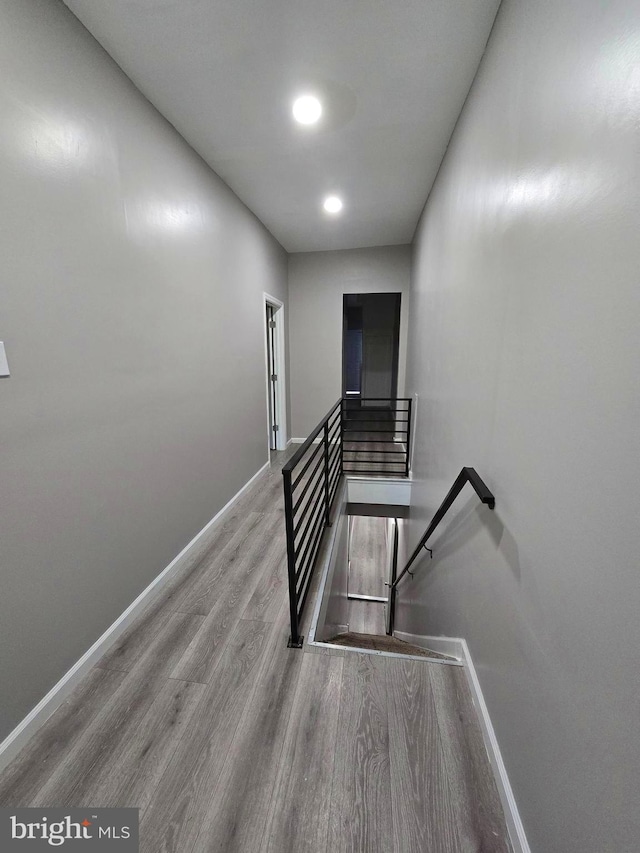 stairway with hardwood / wood-style flooring