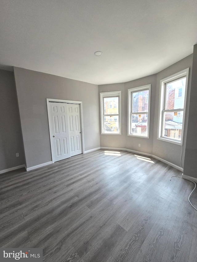 spare room with dark wood-type flooring