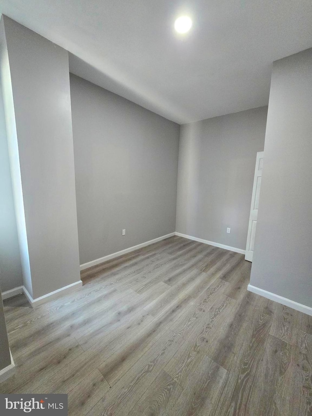 interior space with baseboards and wood finished floors