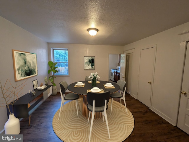 dining room featuring dark hardwood / wood-style flooring and a textured ceiling