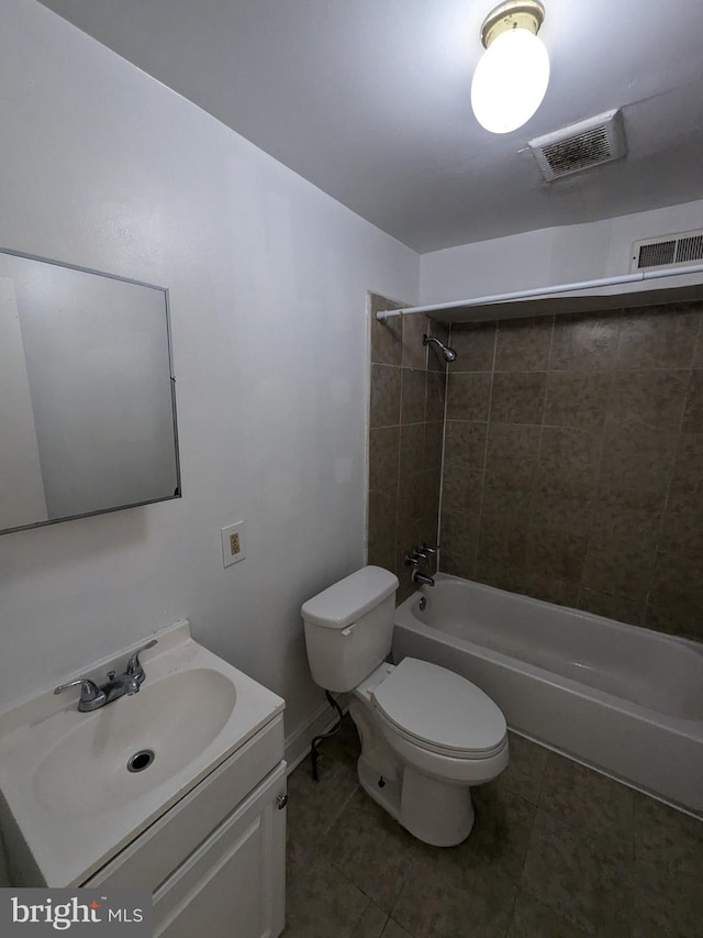 full bathroom with toilet, tiled shower / bath combo, vanity, and tile patterned flooring