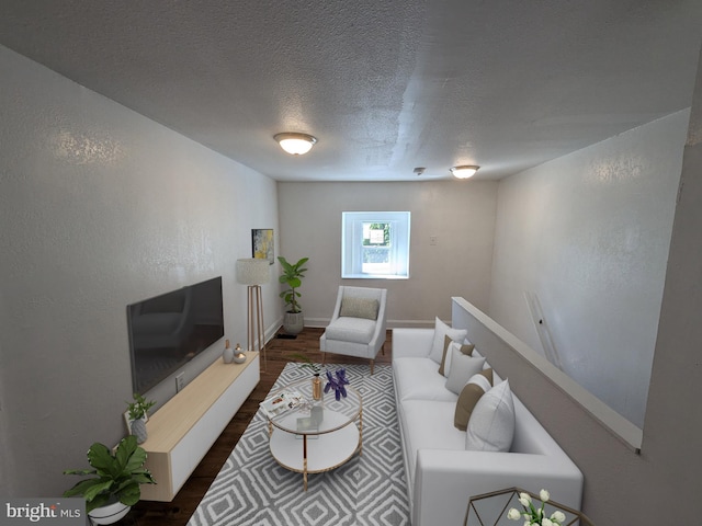 living room featuring dark hardwood / wood-style flooring and a textured ceiling