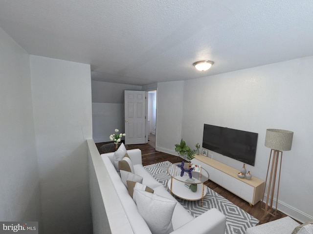 living room featuring dark hardwood / wood-style flooring and a textured ceiling