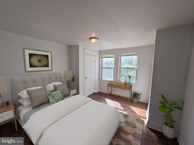 bedroom with hardwood / wood-style flooring and a textured ceiling