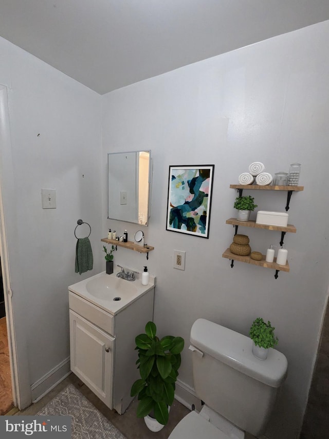 bathroom with toilet and vanity