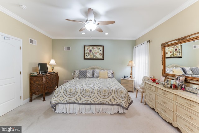 carpeted bedroom with ceiling fan and ornamental molding