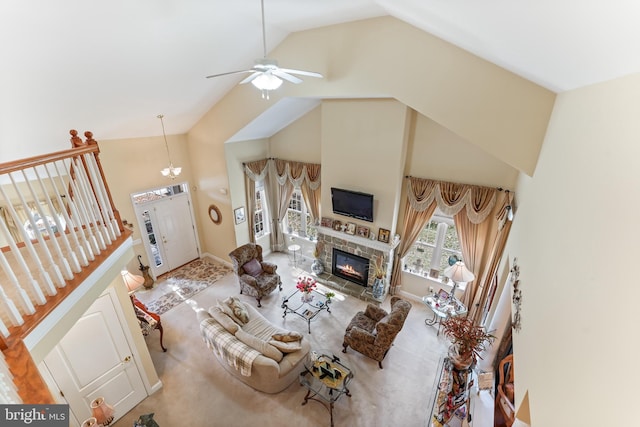 living room featuring high vaulted ceiling, ceiling fan, and a fireplace