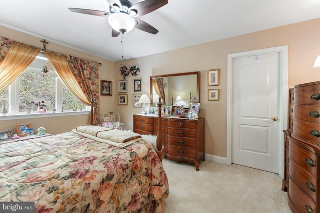 bedroom with ceiling fan and light colored carpet