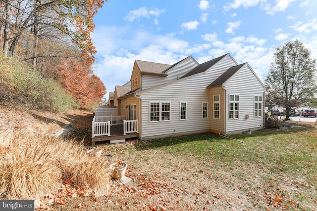 exterior space featuring a lawn and a wooden deck