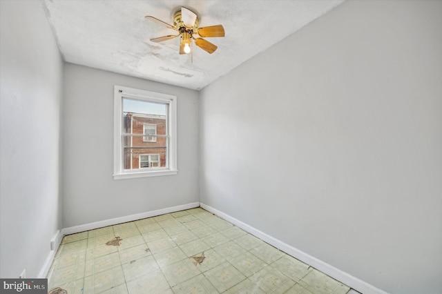 unfurnished room with ceiling fan and a textured ceiling