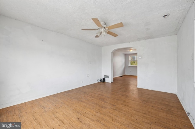 unfurnished room with a textured ceiling, hardwood / wood-style flooring, and ceiling fan