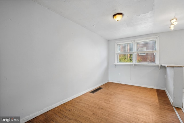 spare room featuring light hardwood / wood-style flooring