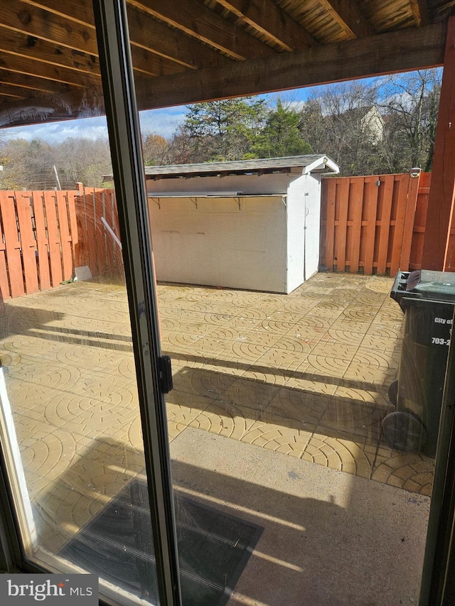 view of patio featuring a storage shed