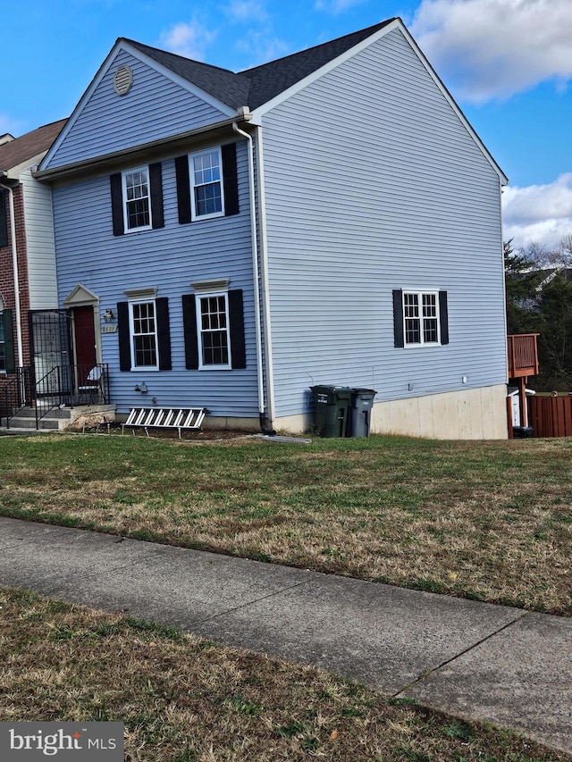 view of side of home with a lawn