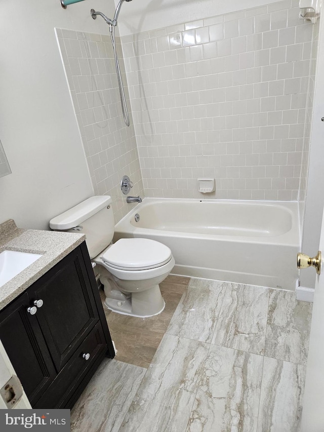 full bathroom featuring vanity, hardwood / wood-style flooring, toilet, and tiled shower / bath