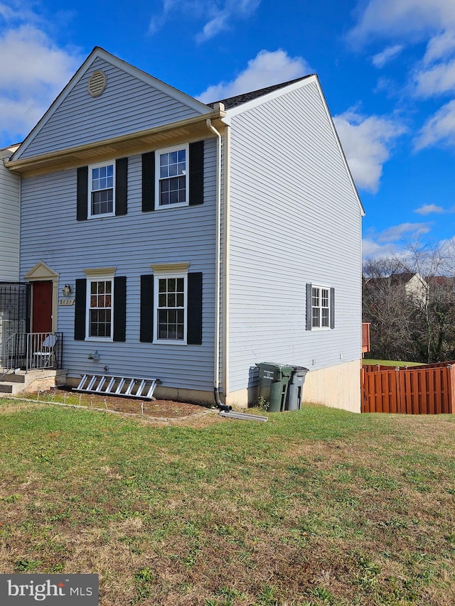 view of side of home with a lawn