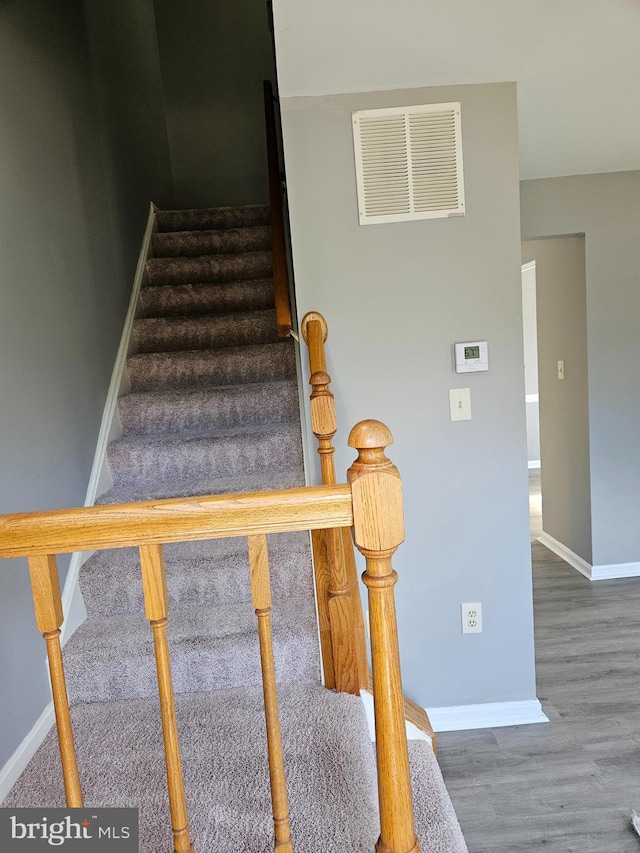 staircase featuring hardwood / wood-style flooring