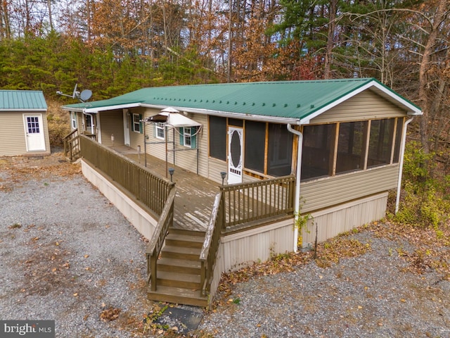 view of front of home with a sunroom