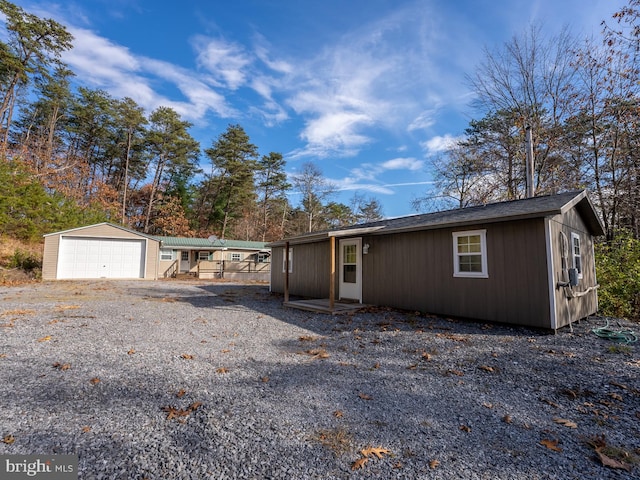 view of front of property featuring a garage and an outdoor structure