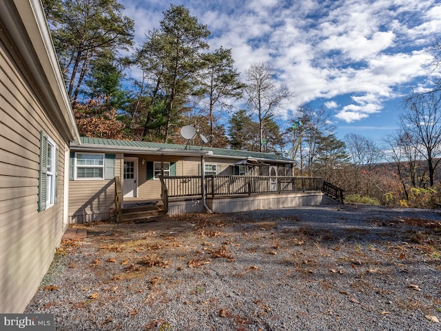 back of property with a wooden deck