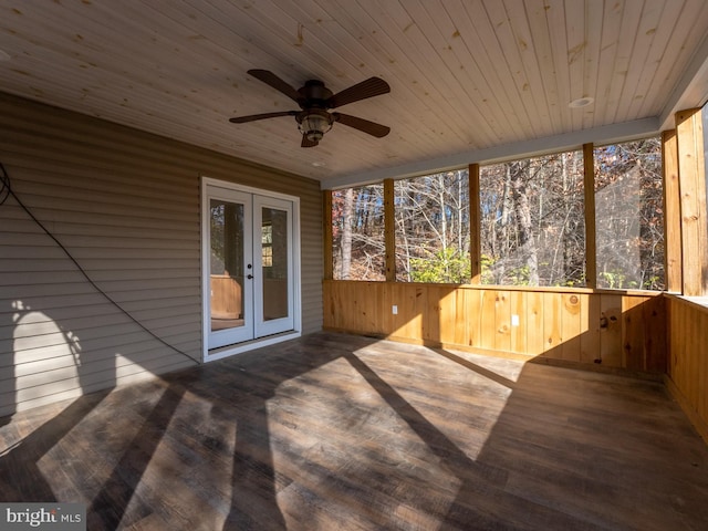 unfurnished sunroom with ceiling fan, wood ceiling, and french doors