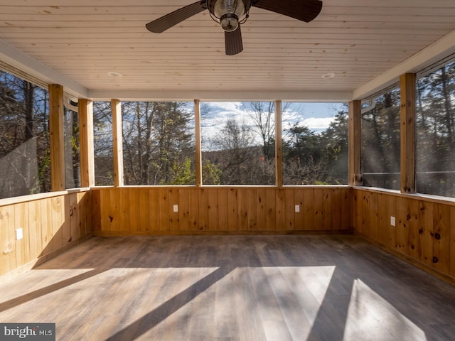 unfurnished sunroom with ceiling fan and wood ceiling